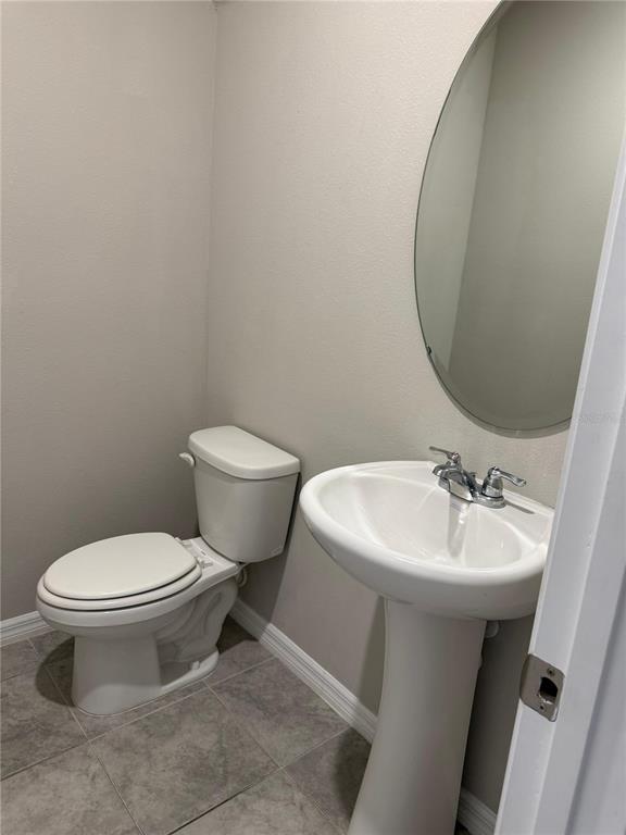 7649 Intrepid Road Wesley Chapel, FL 33545 - Photo 8 of 46 a bathroom with a sink toilet and a mirror