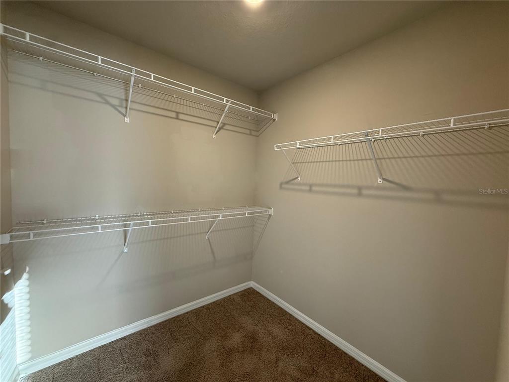 7649 Intrepid Road Wesley Chapel, FL 33545 - Photo 9 of 46 a view of a room with racks on the wall