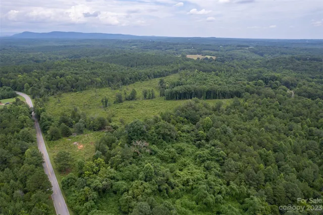 a view of a green field with lots of bushes