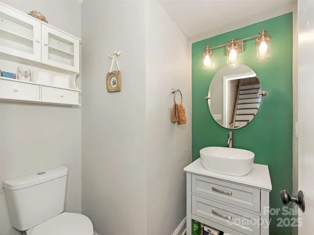 a bathroom with a toilet a sink and mirror