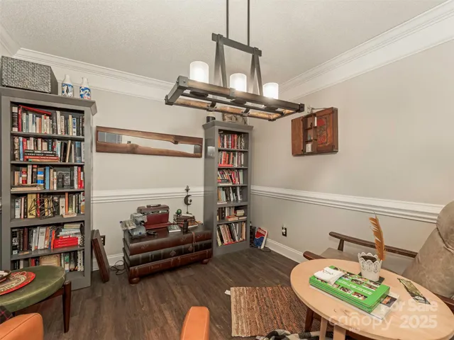 a living room with furniture a rug and a book shelf