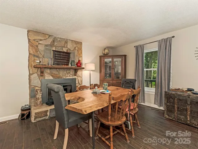 a dining room with furniture window and wooden floor