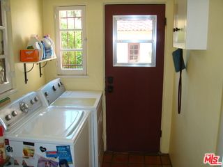 a view of a patio with couches table and chairs and potted plants