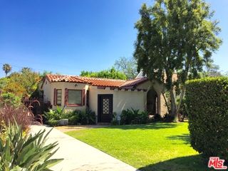 a living room with yard table and chairs