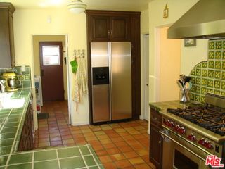 a kitchen with a stove and a refrigerator