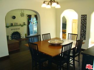a front view of a house with a fountain
