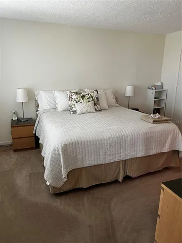 a bedroom with a bed and lamp