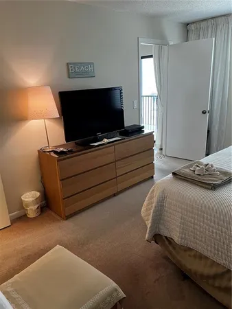 a bedroom with a bed and flat screen tv
