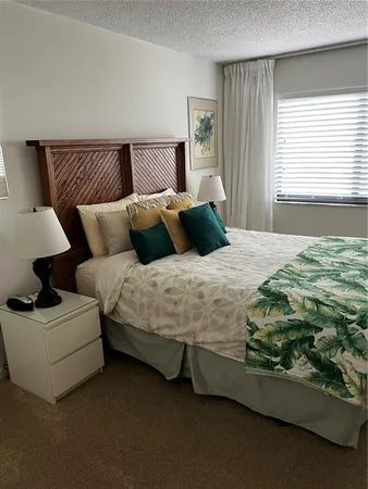 a bedroom with a bed couch and window