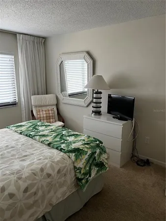 a bedroom with a bed and a tv