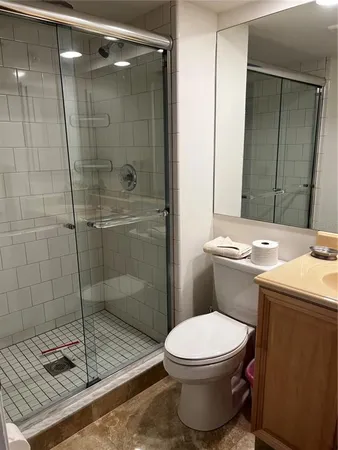 a bathroom with a toilet sink and shower