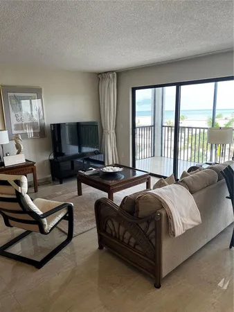 a bedroom with a bed couch and a large window