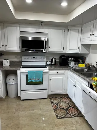 a kitchen with a stove a microwave and cabinets