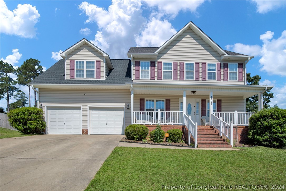 101 Lattimore Road Cameron, NC 28326 - Photo 1 of 33 a front view of a house with a yard and garage
