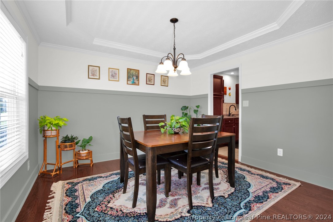 101 Lattimore Road Cameron, NC 28326 - Photo 11 of 33 a view of a dining room with furniture and a chandelier