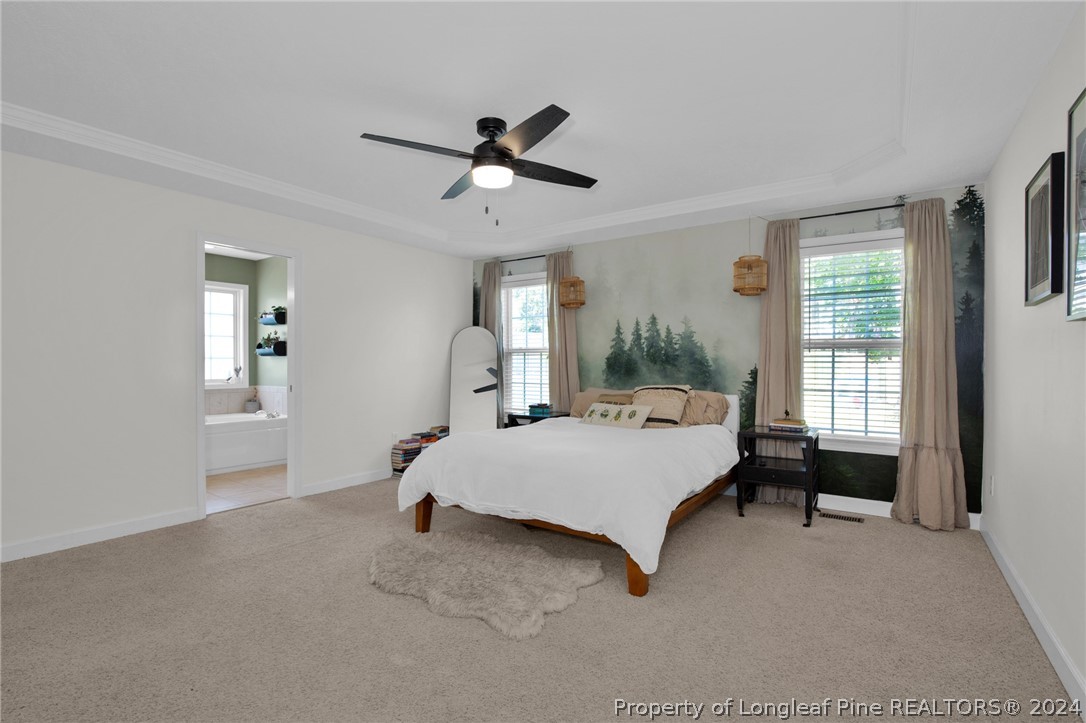 101 Lattimore Road Cameron, NC 28326 - Photo 13 of 33 a spacious bedroom with a bed and a window