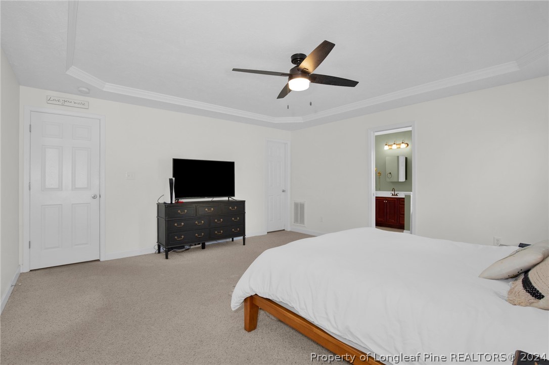 101 Lattimore Road Cameron, NC 28326 - Photo 14 of 33 a bedroom with a bed and a flat screen tv