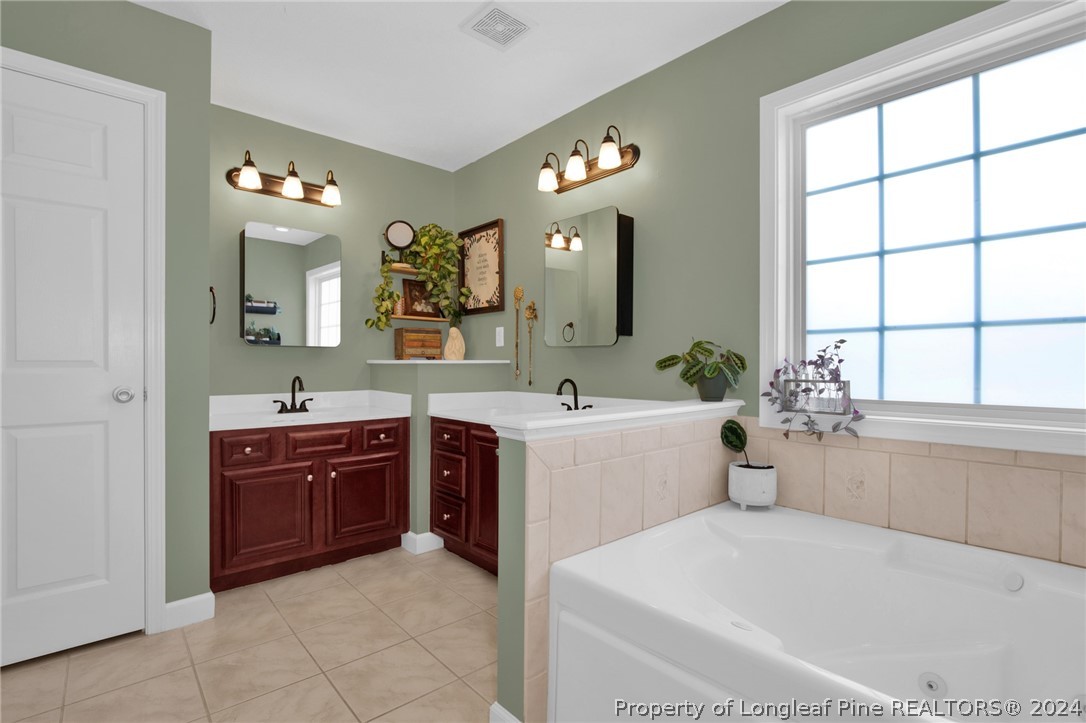 101 Lattimore Road Cameron, NC 28326 - Photo 15 of 33 a spacious bathroom with a tub sink and mirror