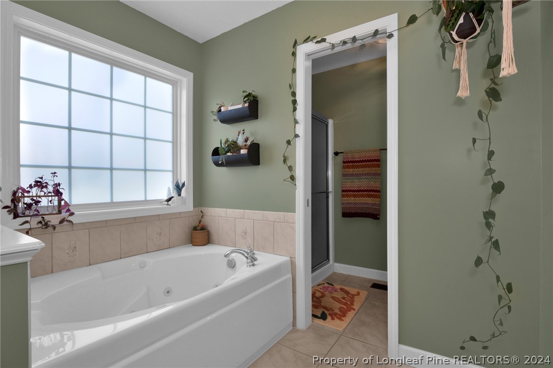 101 Lattimore Road Cameron, NC 28326 - Photo 17 of 33 a bathroom with a bathtub and a shower