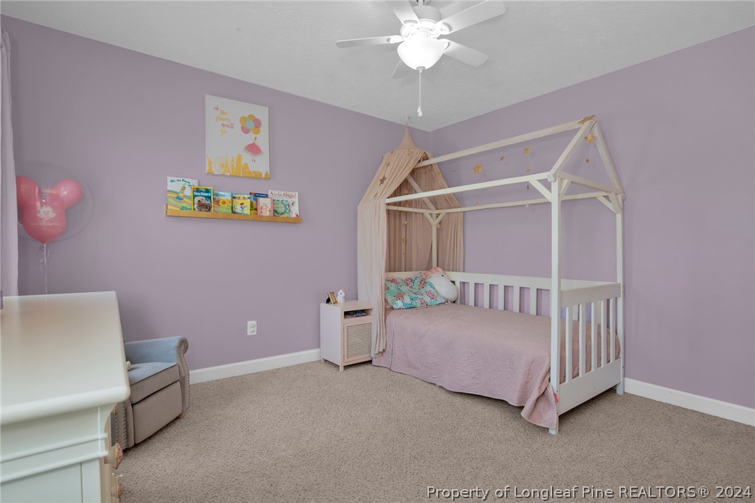 101 Lattimore Road Cameron, NC 28326 - Photo 22 of 33 a bedroom with a bed and a chandelier