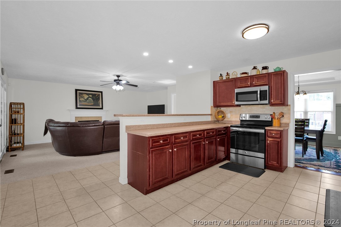 101 Lattimore Road Cameron, NC 28326 - Photo 7 of 33 a large kitchen with stainless steel appliances and a sink