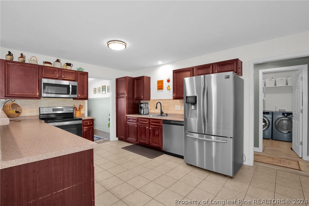 101 Lattimore Road Cameron, NC 28326 - Photo 8 of 33 a kitchen with stainless steel appliances a refrigerator and a sink