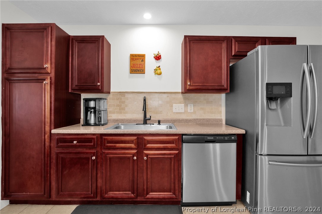 101 Lattimore Road Cameron, NC 28326 - Photo 10 of 33 a kitchen with stainless steel appliances granite countertop a refrigerator and a sink