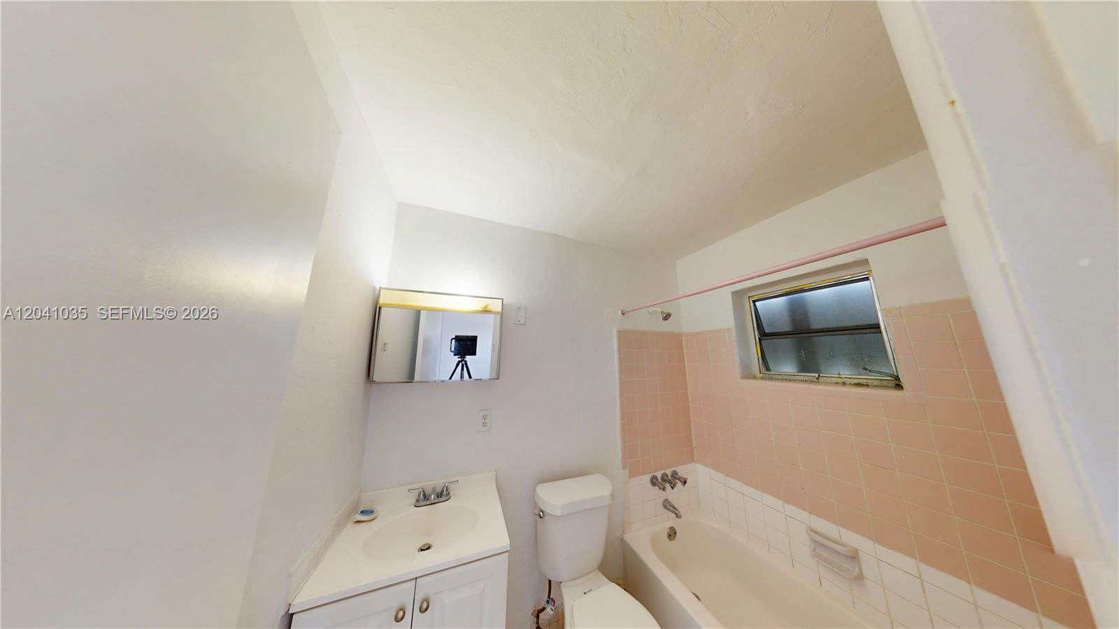 6811 Southwest 16th Street Miami, FL 33144 - Photo 13 of 21 a bathroom with a toilet sink and mirror