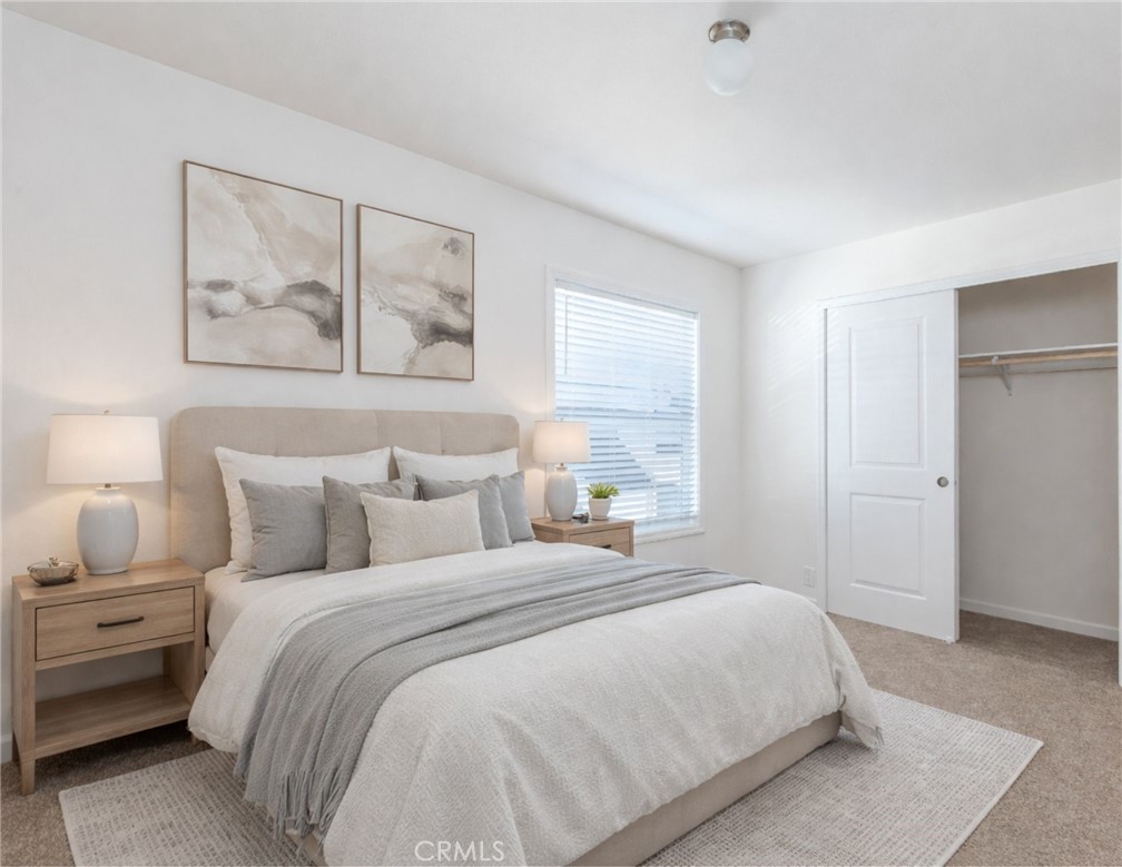 3210 Santa Maria Way, Unit 21 Santa Maria, CA 93455 - Photo 8 of 13 a bedroom with a large bed and a painting on the wall