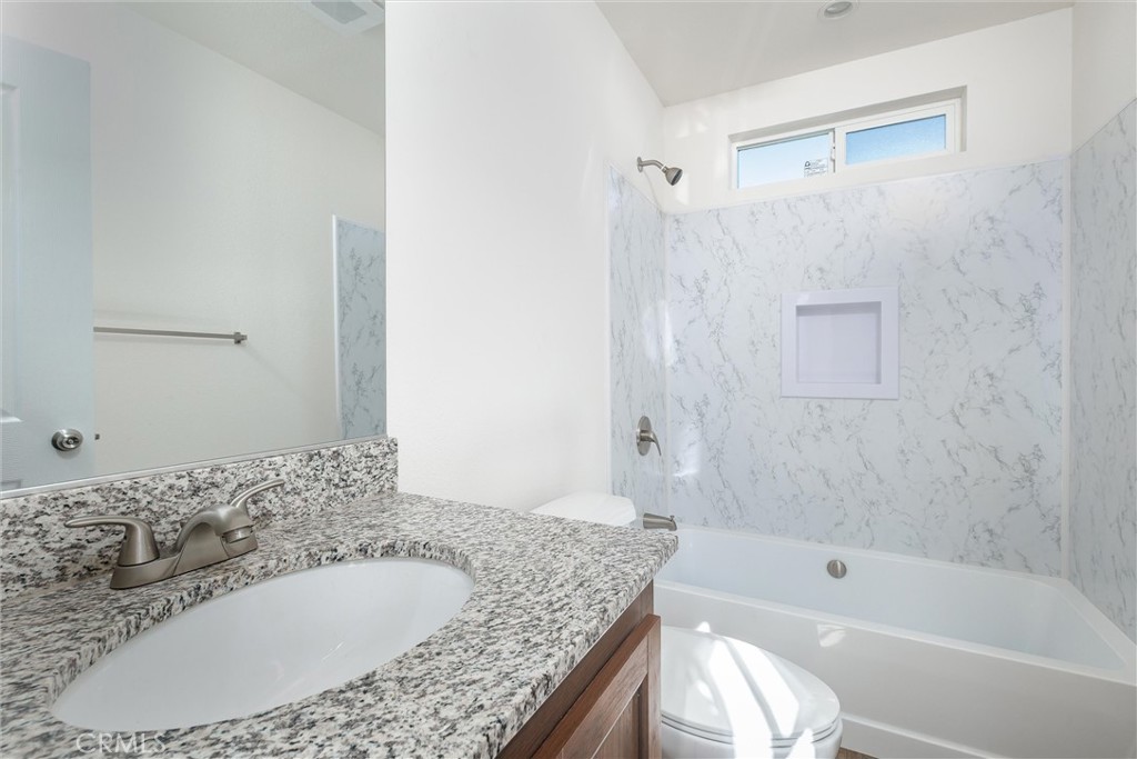 3210 Santa Maria Way, Unit 21 Santa Maria, CA 93455 - Photo 10 of 13 a bathroom with a granite countertop tub sink and mirror