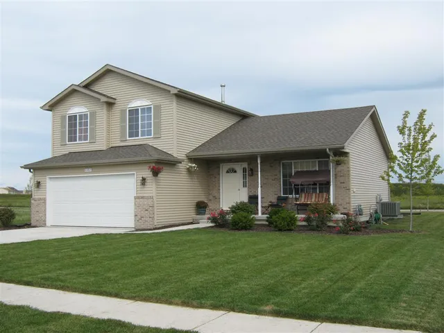 a front view of a house with a garden and plants