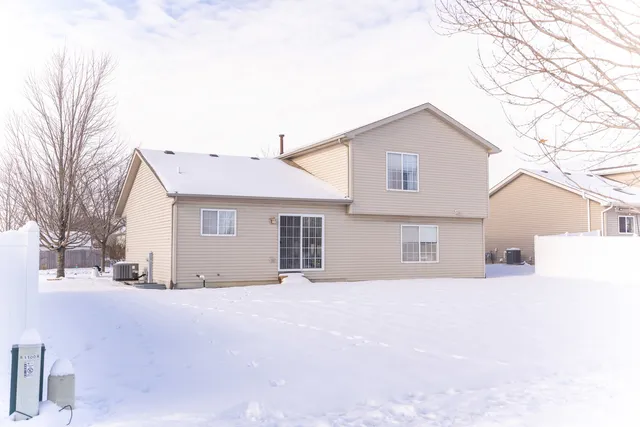 a view of a house with a snow in the yard