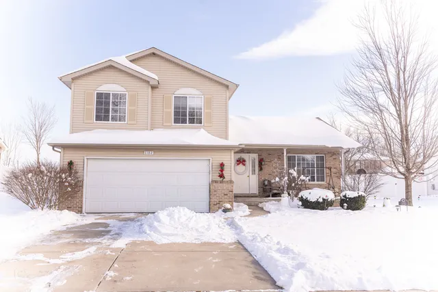 a view of a white house with a snow on the road