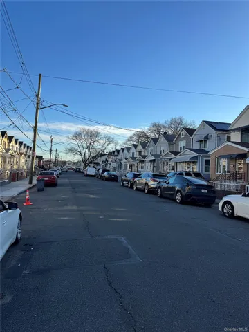 a view of a city street with couple of cars parked