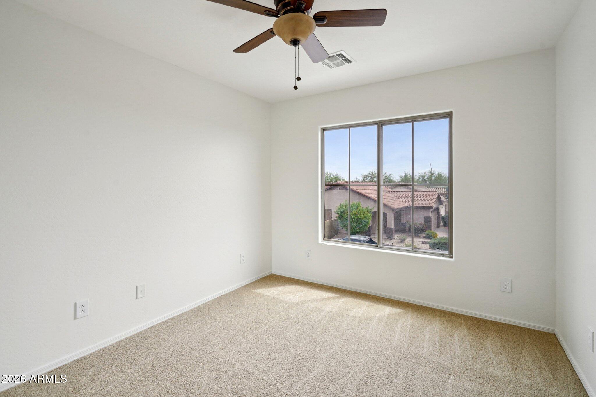 3852 West Ranier Court Anthem, AZ 85086 - Photo 30 of 58 a view of an empty room with a window