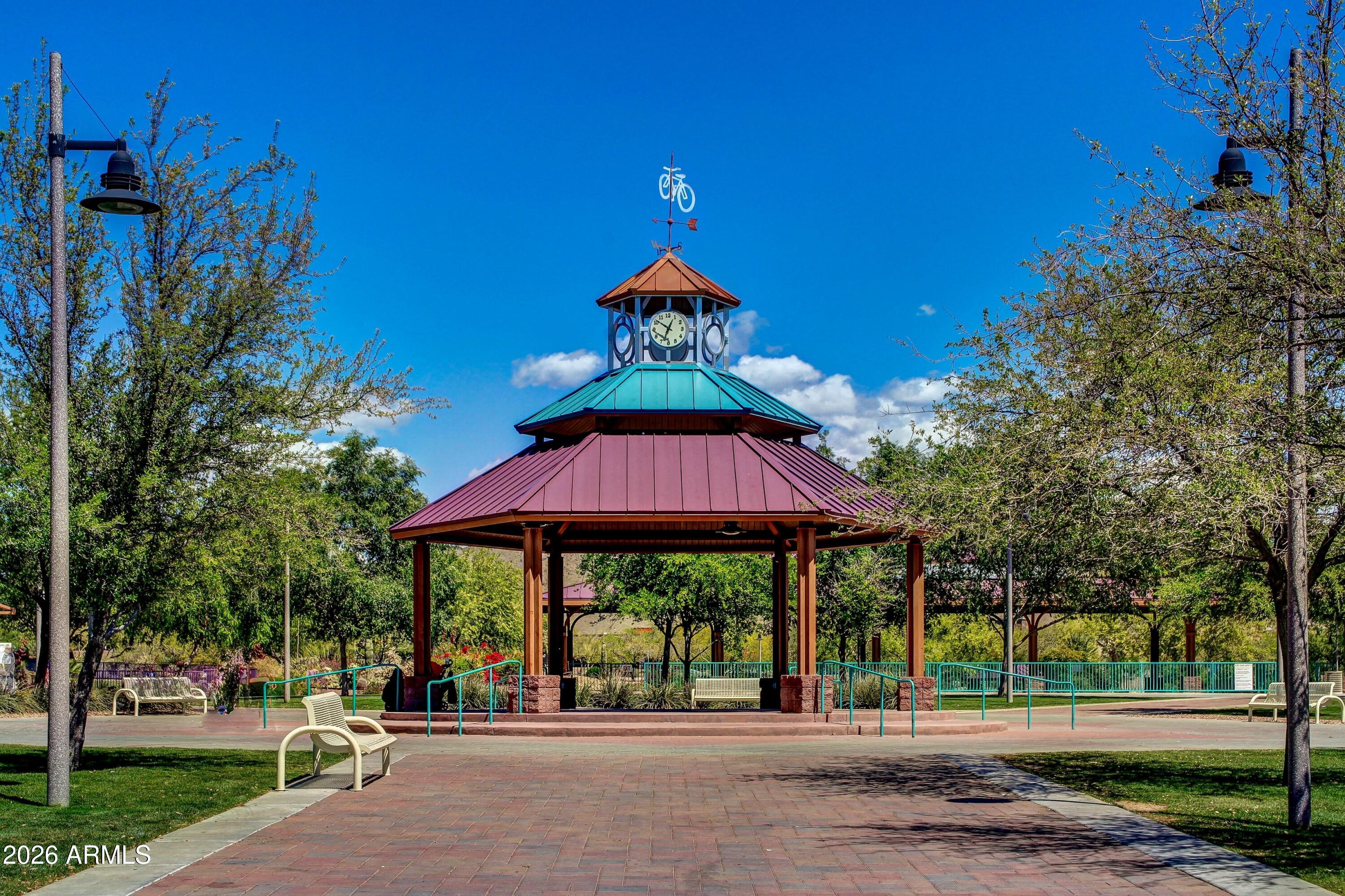 3852 West Ranier Court Anthem, AZ 85086 - Photo 57 of 58 a man sitting on a bench in front of a building