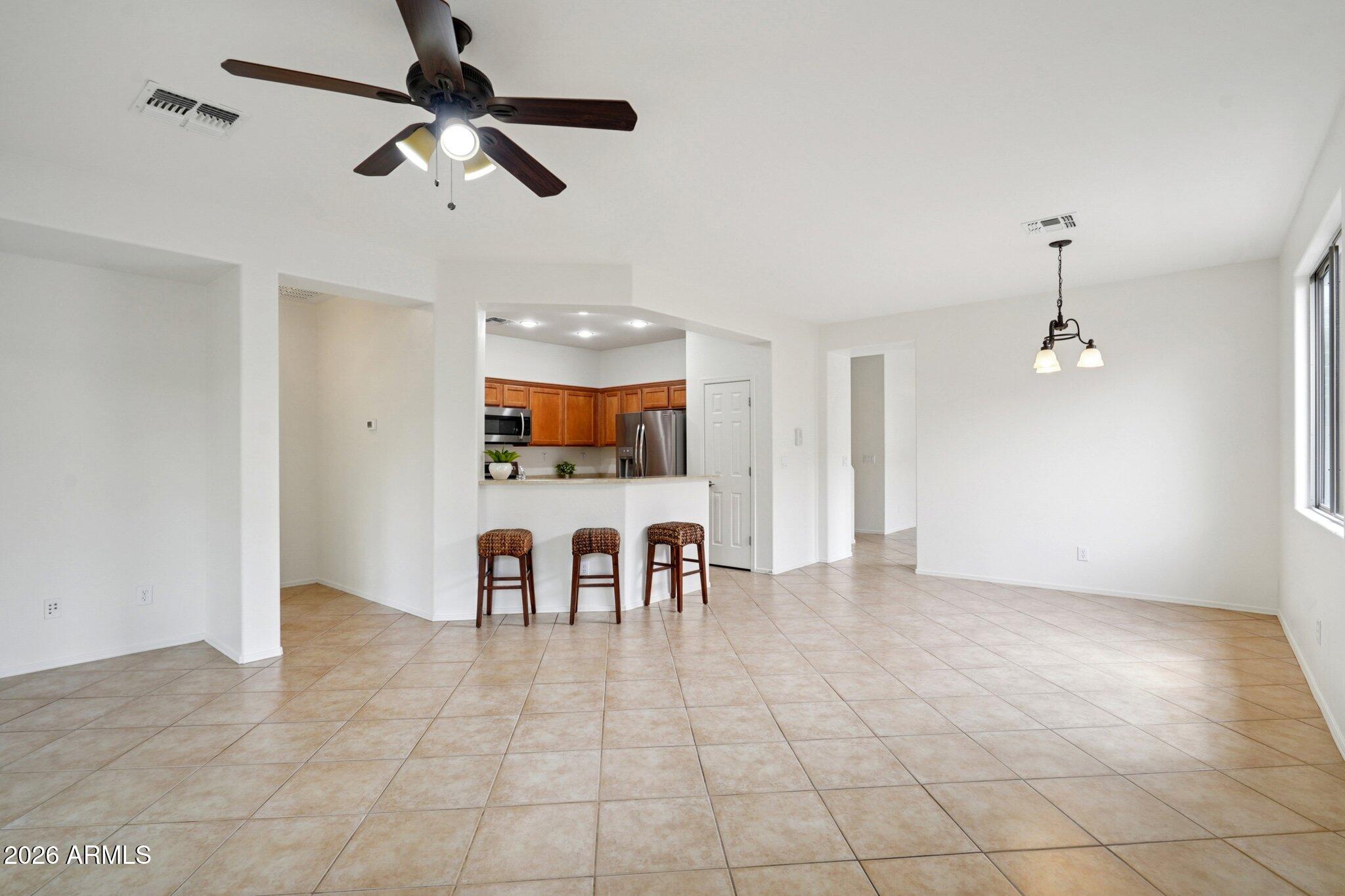 3852 West Ranier Court Anthem, AZ 85086 - Photo 7 of 58 a view of dining room with furniture and chandelier fan