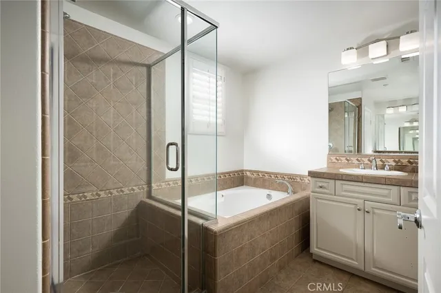 a bathroom with a tub sink shower and mirror