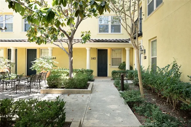 a front view of a house with trees