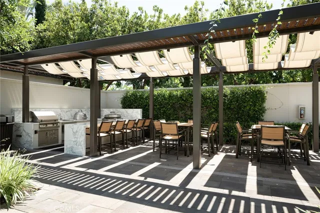 a view of a white house with a yard and potted plants