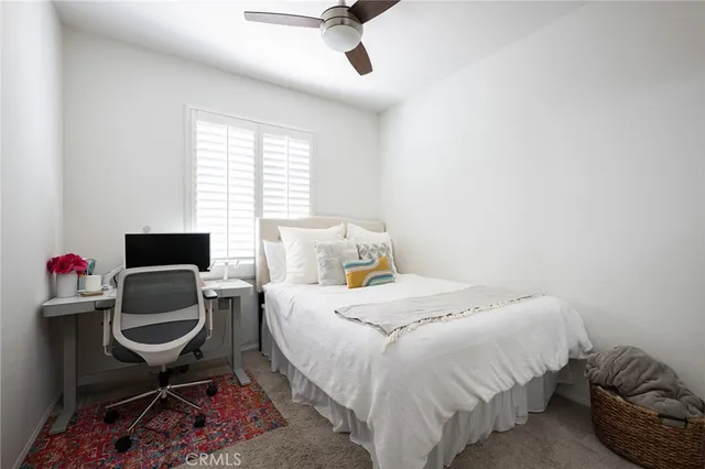 a bedroom with a bed and chair