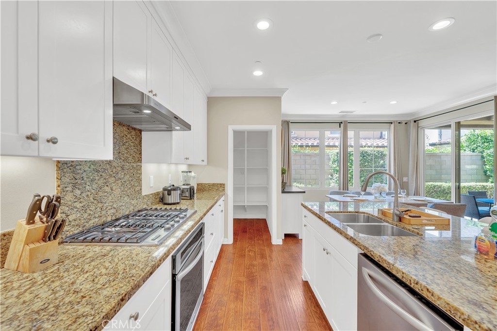 75 Gardenstone Path Irvine, CA 92620 - Photo 22 of 65 a kitchen with a stove sink and cabinets