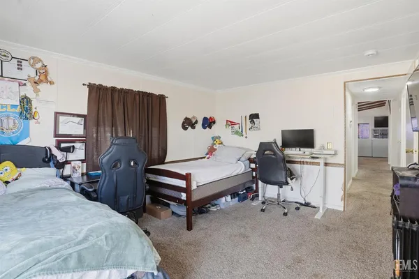 a bedroom with furniture and a flat screen tv