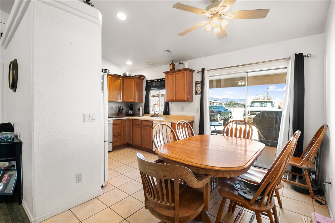3668 North Neptune Road Golden Valley, AZ 86413 - Photo 24 of 38 The dining area features a wooden table with chairs, tile flooring, and a ceiling fan