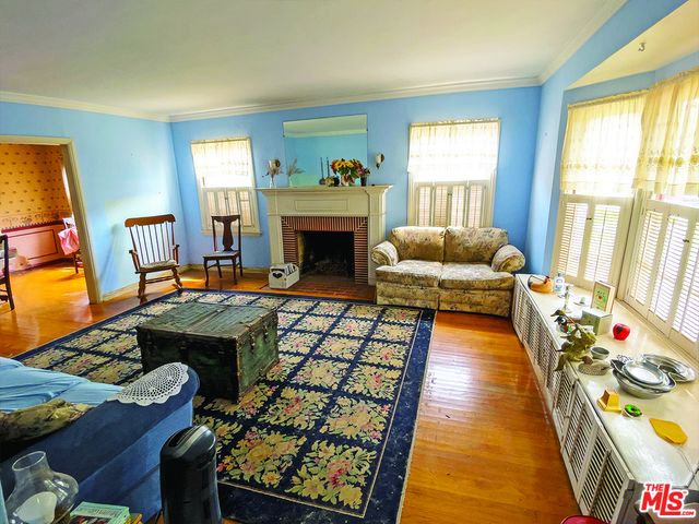a living room with furniture fireplace and a table