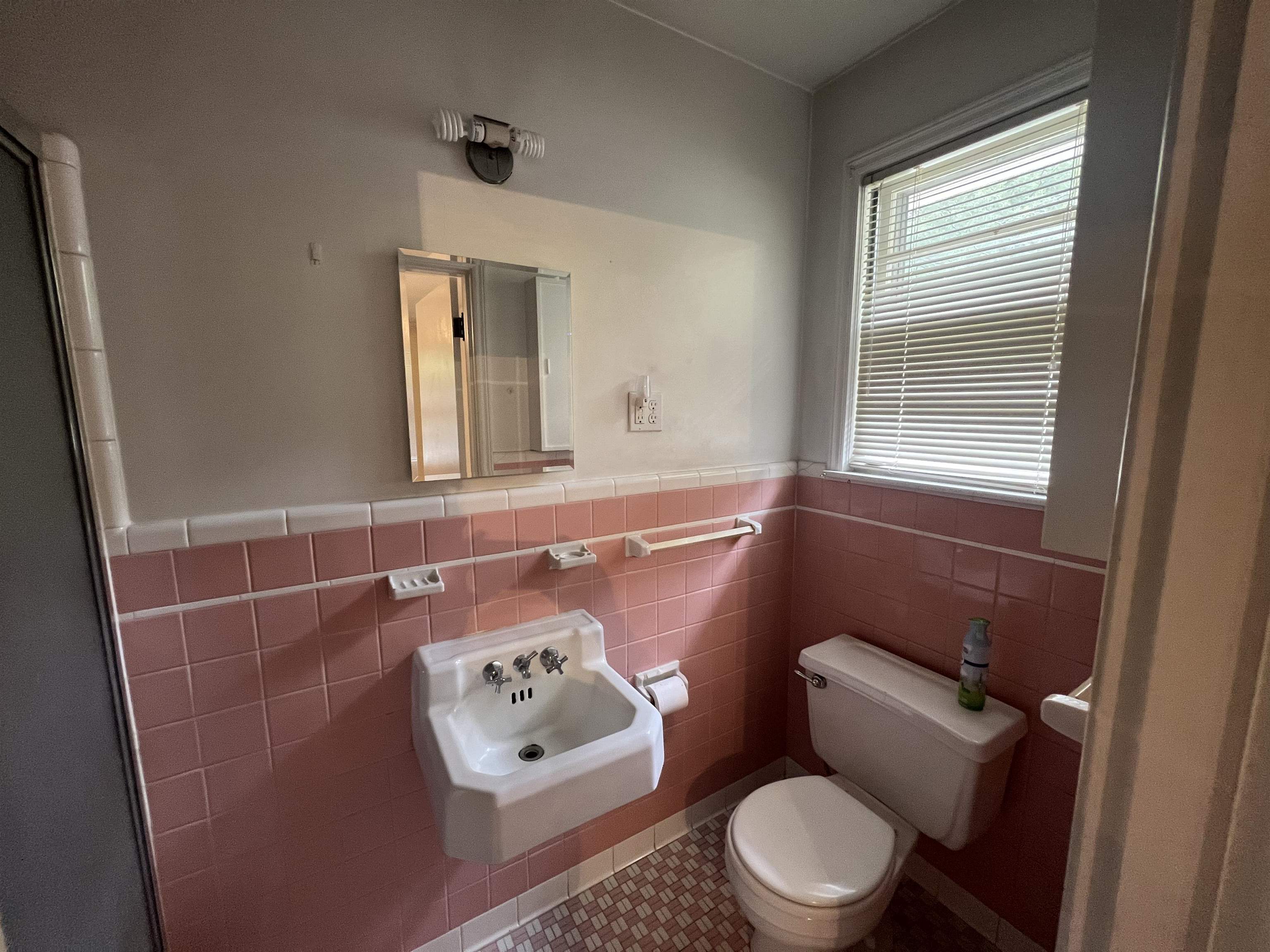 1048 West Perkins Road Memphis, TN 38117 - Photo 11 of 15 a bathroom with a toilet a sink and a window
