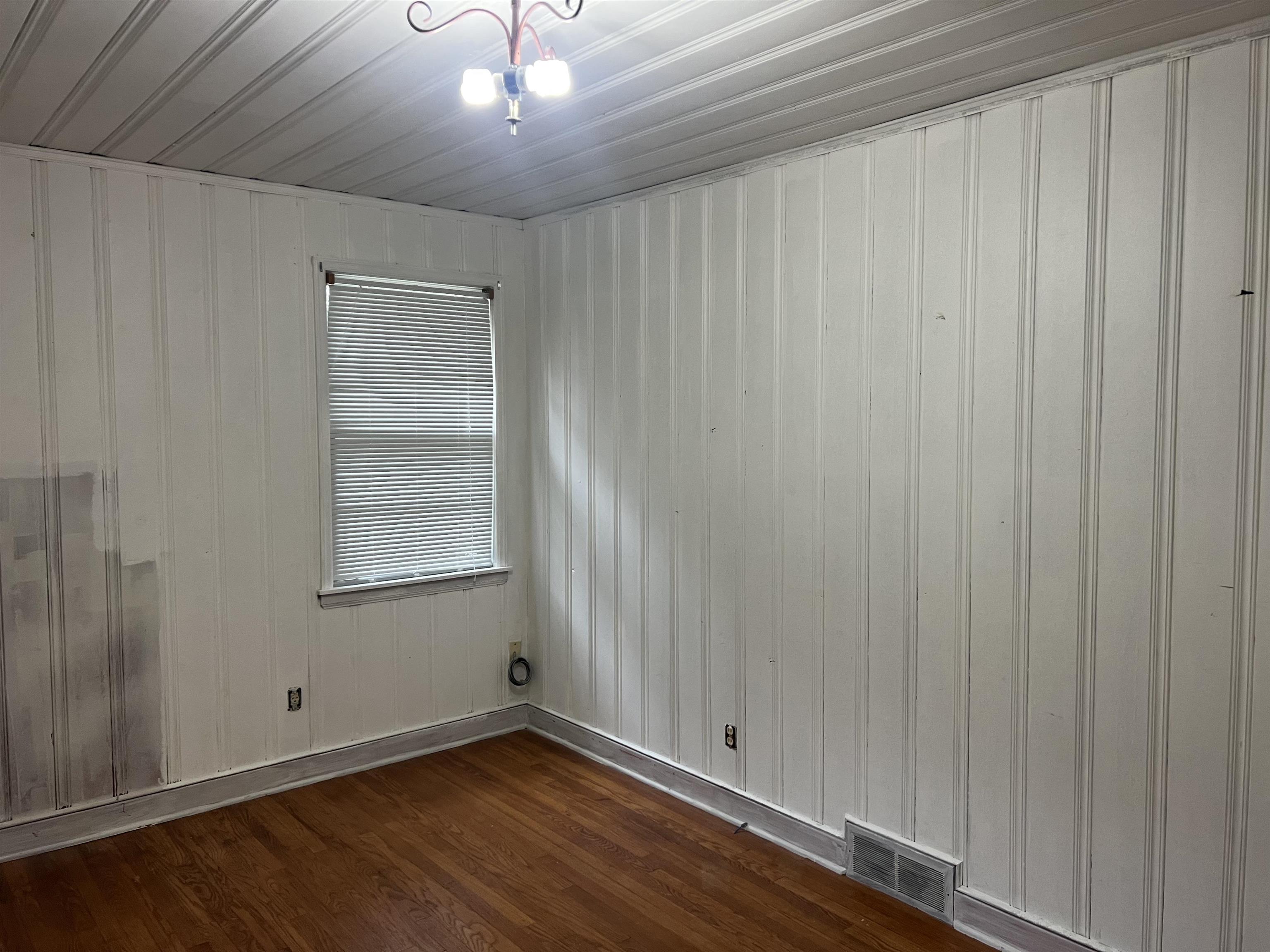 1048 West Perkins Road Memphis, TN 38117 - Photo 12 of 15 a view of an empty room with wooden floor and a window