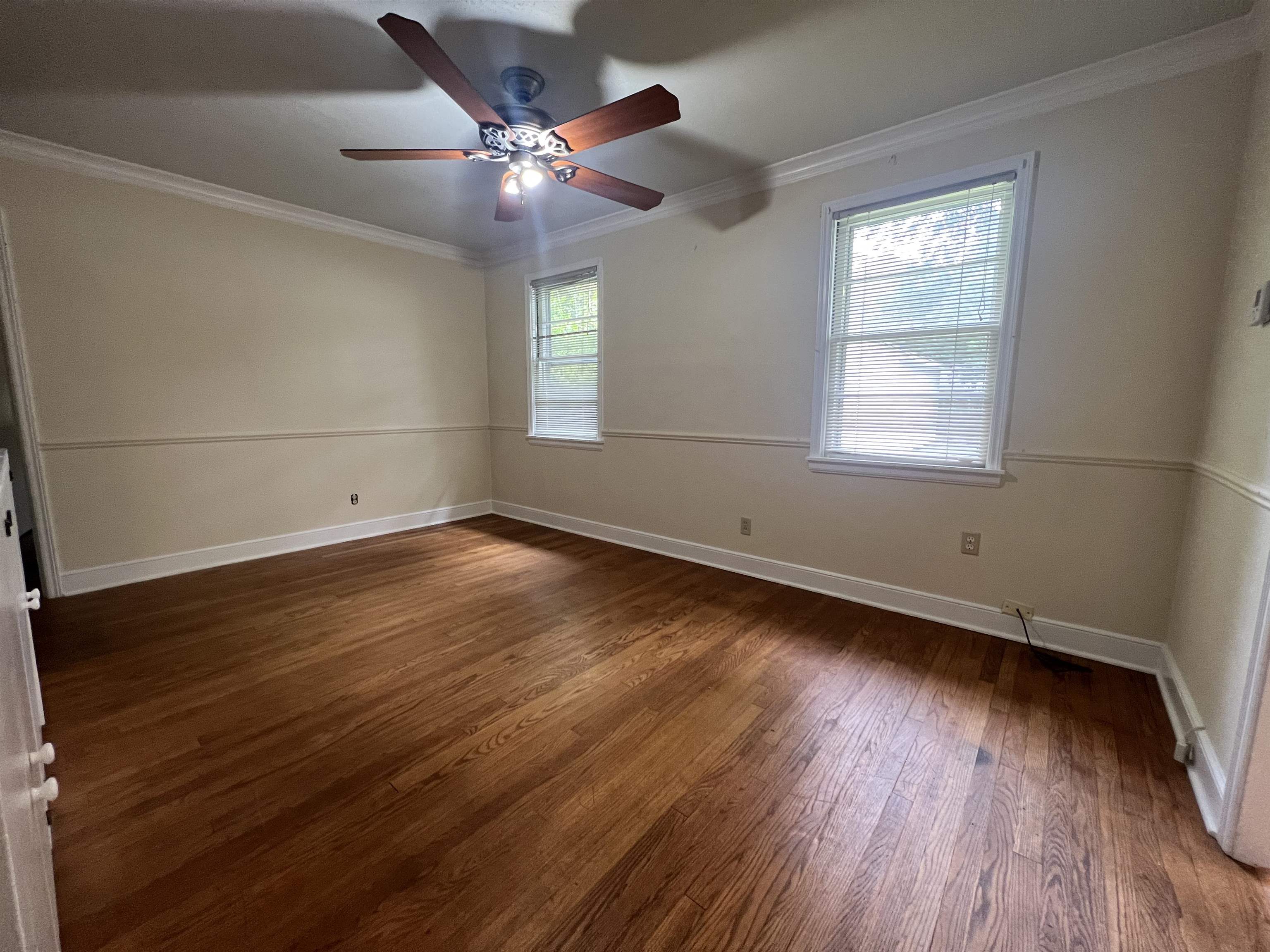 1048 West Perkins Road Memphis, TN 38117 - Photo 6 of 15 an empty room with wooden floor and windows