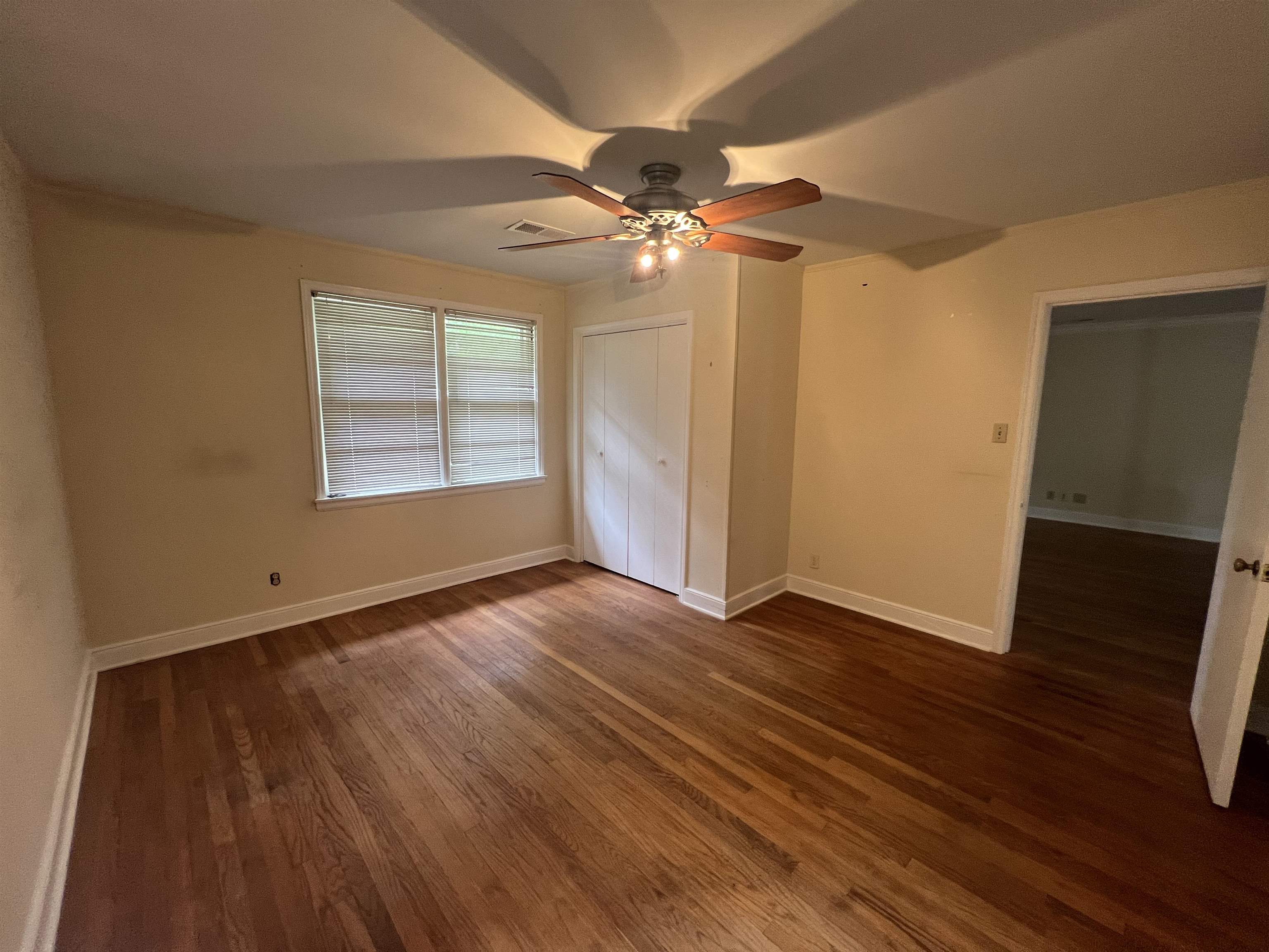 1048 West Perkins Road Memphis, TN 38117 - Photo 10 of 15 wooden floor in an empty room with a window