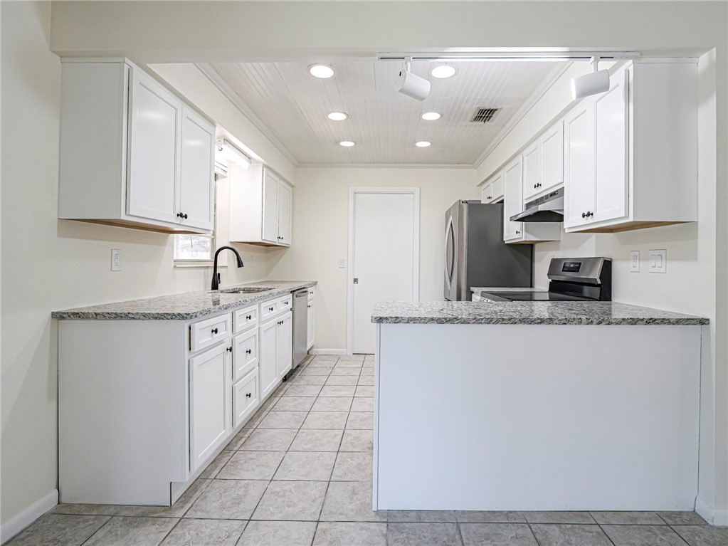 1331 Barber Street Sebastian, FL 32958 - Photo 7 of 32 a kitchen with stainless steel appliances granite countertop a sink and cabinets